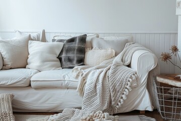 Fototapeta na wymiar A white couch with matching pillows in a modern living room setting