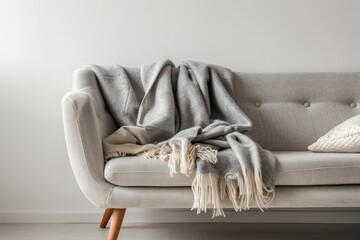 A couch with a cozy blanket resting on top of it, adding warmth and comfort to the living room decor