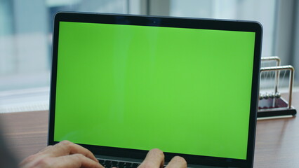 Unrecognizable manager working green screen laptop standing office table closeup