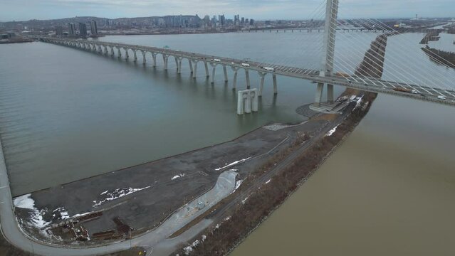 Reveal of downtown Montreal over Champlain Bridge and St-Laurent river
