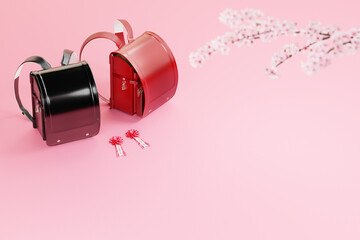 ピンクの背景に置かれた赤と黒のランドセルと桜の枝 / 入学式・春の新生活のコンセプトイメージ / コピースペース / 3Dレンダリング