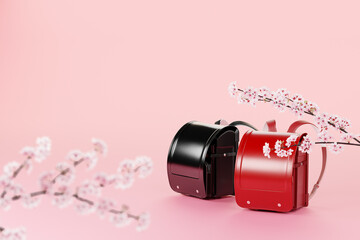 ピンクの背景に置かれた赤と黒のランドセルと桜の枝 / 入学式・春の新生活のコンセプトイメージ / コピースペース / 3Dレンダリング