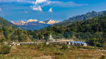 Landscape View of Jamuni Bridge Shiva Statue , overlooking  the Majestic Kangchenjunga, also spelled Kanchenjunga at Darjeeling District.