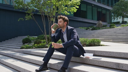 Manager enjoy lunch break on city stairs. Office worker eating sandwich drinking