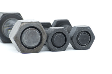 Black metal bolts and nuts arranged on white background