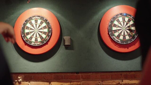 Two Players Throwing Darts during Dart Match
