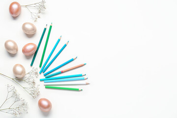 Pencils, gypsophila and Easter eggs on white background. Easter concept.