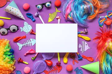 Blank card with paper fishes and party decor on purple background. April Fools Day celebration - obrazy, fototapety, plakaty