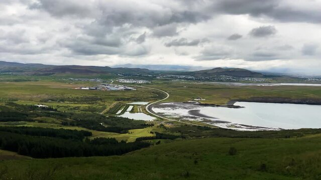 View on Leirvogstunga town from Esjan hiking trail in mountains, pan right