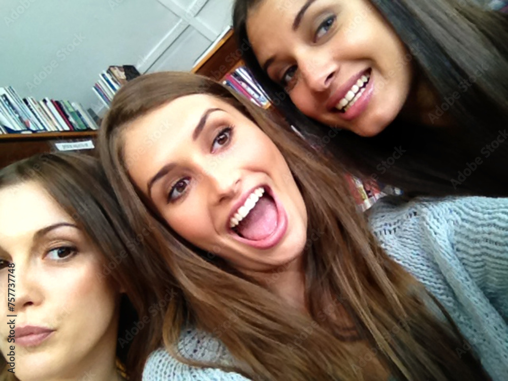Poster women, university student and happy with selfie as friends in library for study break or group work 