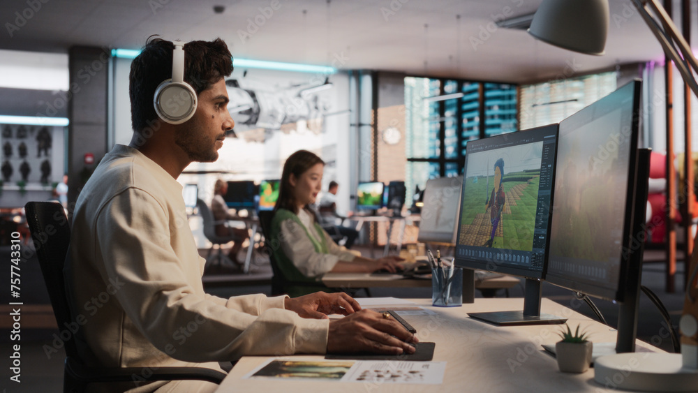 Aufkleber Indian Male Game Designer Using Desktop Computer With 3D Modelling Software To Design Unique Characters And World For Immersive RPG Video Game. Man Working In Game Development Company Diverse Office