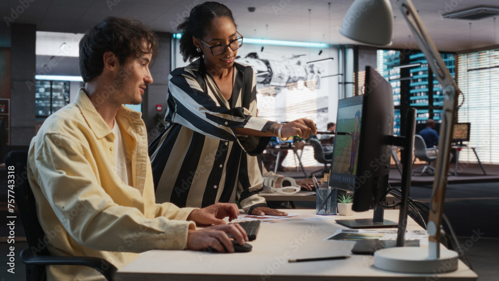 Poster Caucasian Male Game Designer Using Desktop Computer With 3D Modelling Software And Talking to Black Female Project Manager in Game Development Studio Office. Diverse Colleagues Discussing New RPG Game