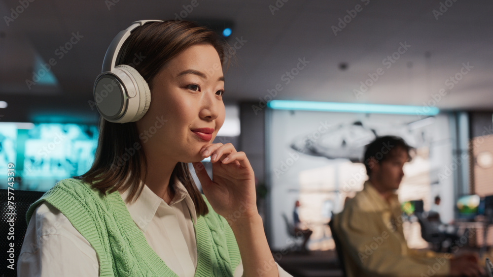 Poster Female Asian Game Designer Using Desktop Computer, Designing Unique World And Characters In 3D modelling Software For Adventure Video Game. Woman Working In Diverse Game Development Studio Office