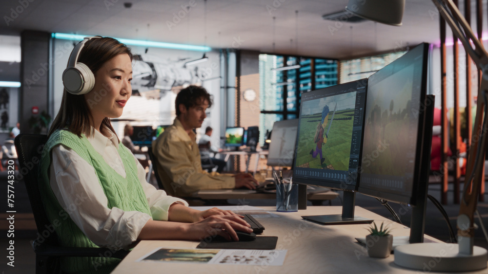 Poster Female Asian Game Designer Using Desktop Computer, Designing Unique World And Characters In 3D modelling Software For RPG Video Game. Woman Working In Diverse Game Development Studio Office