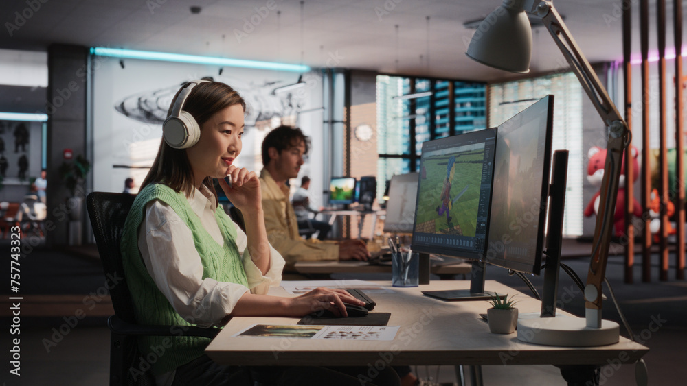 Poster Female Asian Game Designer Using Desktop Computer, Designing Unique World And Characters In 3D modelling Software For RPG Video Game. Woman Working In Diverse Game Development Studio Office