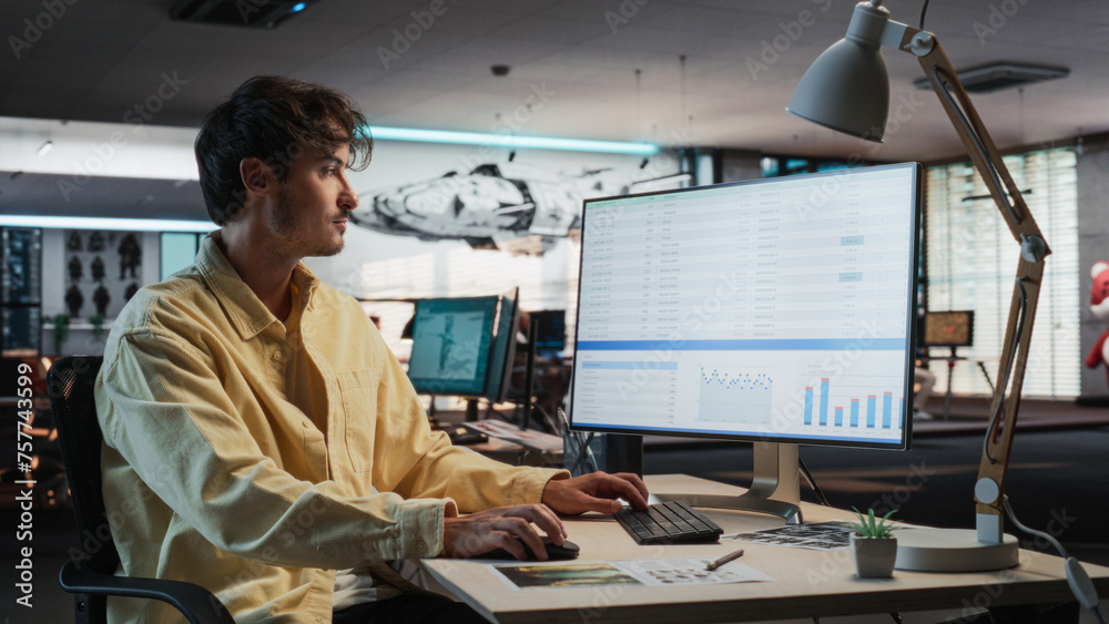Poster Caucasian Male Manager Using Desktop Computer With Analytics Software wth Financial Reports. Man Working In Game Development Company Diverse Office