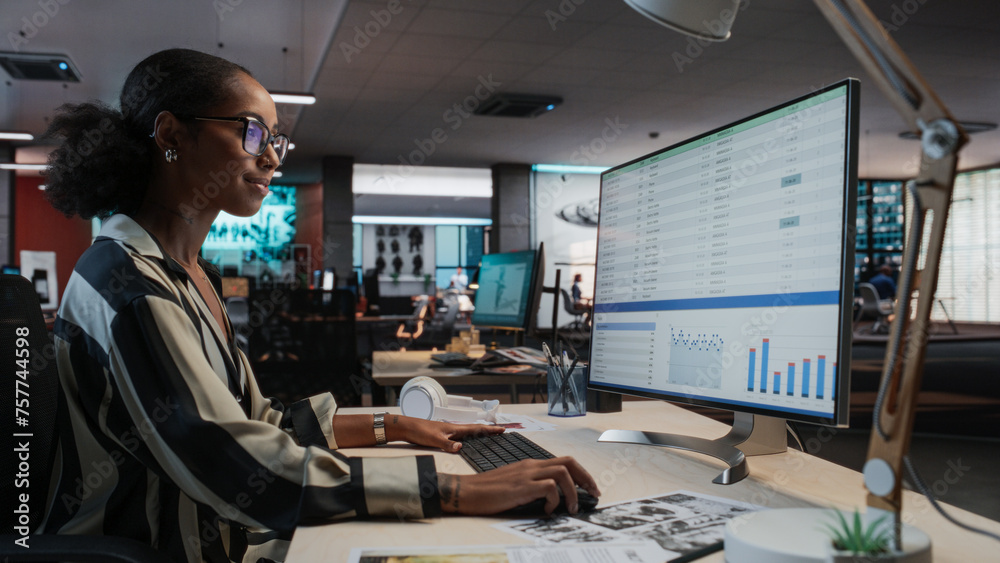 Aufkleber African Female Manager Using Desktop Computer With Analytics Software wth Financial Reports. Woman Working In Game Development Company Diverse Office