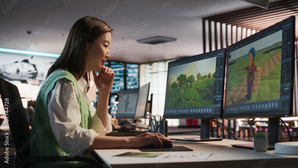 Aufkleber Female Asian Game Designer Using Desktop Computer, Designing Unique World And Characters In 3D modelling Software For RPG Video Game. Woman Working In Diverse Game Development Studio Office.