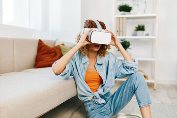 Virtual Reality Fun at Home: Smiling Woman Enjoying Cyber Game with VR Glasses on a Sofa indoors