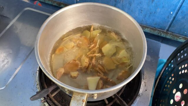 Boiling ginger in a hot pot at home kitchen. Healthy lifestyle concept
