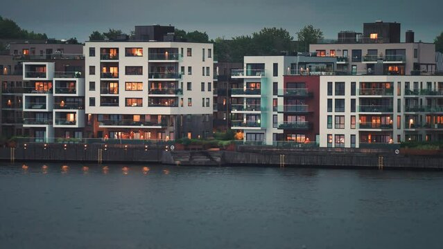 Modern residential buildings with brightly lit windows in the coastal quarter of the Kristiansand city.