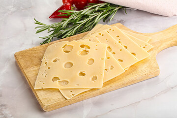 Sliced maasdam cheese with holes
