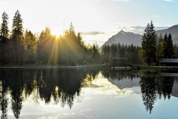 Alpine Lake Paradise: Lush Forest Meets Majestic Mountains at Sunrise
