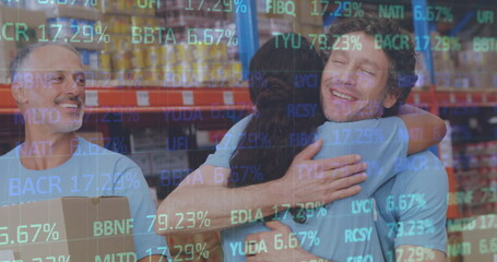 Stock market data processing against diverse male and female volunteers hugging at warehouse