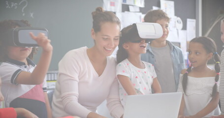 Image of mathematical equations over schoolchildren using vr headsets