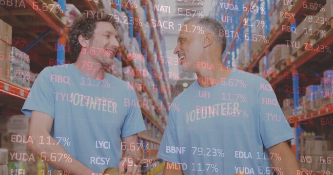 Stock market data processing over two caucasian male volunteers high fiving each other at warehouse - Powered by Adobe