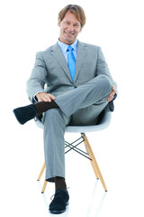 Happy businessman, sitting and studio portrait with confidence in corporate career and professional in suit. Entrepreneur, smile or face in chair for job satisfaction or ambition by white background