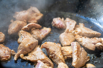 Golden delight: Pork tenderloin pieces in the skillet.
