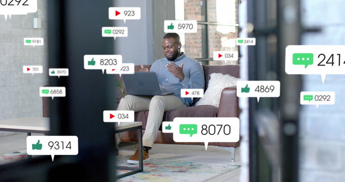 Social media notifications over happy african american casual businessman having laptop image call