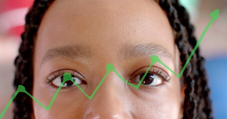 Image of diagram over biracial businesswoman opening eyes in office