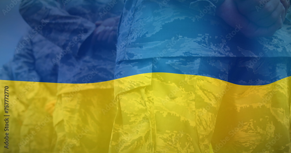 Wall mural Image of flag of ukraine over midsection of diverse male soldiers