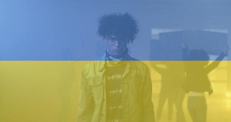 Image of flag of ukraine over african american male protester