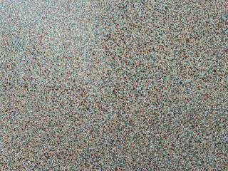 Abstract background with mulit-colored pattern and texture of a terrazzo gravel wall or floor surface.