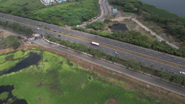 Aerial video of The Outer Ring Road, officially State Highway 234 (SH 234), is a major transport corridor along the periphery of Chennai Metropolitan Area (CMA). Less moving vehicles on an expressway.