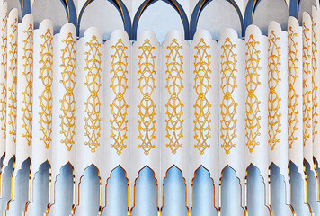 Colorful gilded ornaments and patterns on the wall of a mosque in the Arabic style. Eastern...