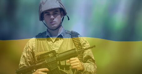 Obraz premium Image of flag of ukraine over caucasian soldier with weapon