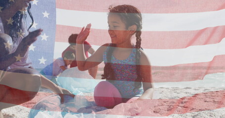 Image of flag of united states of america over biracial couple with children by seaside