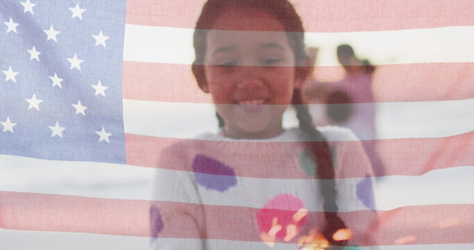 Biracial girl smiles behind a translucent American flag - Powered by Adobe