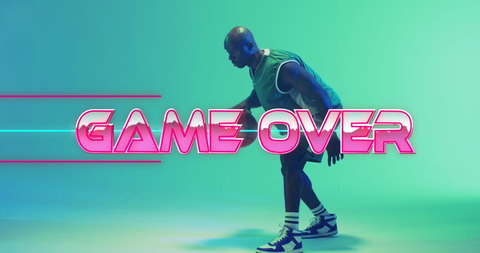 Image of game over text over neon pattern and african american basketball player