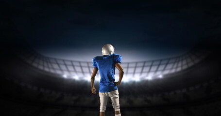 Rear view of an American football athlete limbering up preparing to enter a digital stadium 4k