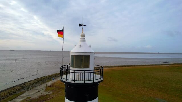 Little Preusse lighthouse - Wurster North Sea coast - Wremen - Northern Germany - sideways flyby Aerial view with a fantastic view of the Wadden Sea in the background	