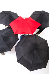 Group of people hiding under umbrellas.