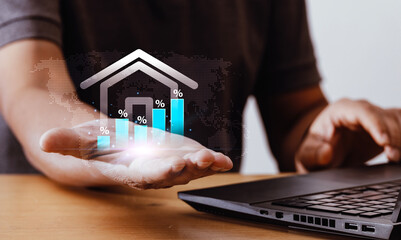 Businessman holds growth graph and house icon on virtual screen. Real estate investment ideas Home mortgage analysis and real estate mortgage insurance interest rate investment planning
