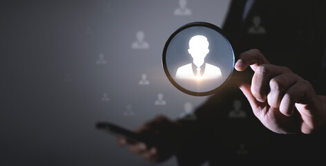 Human Resource Management or HRM, Senior executives using magnifier glass focus to manager icon for recruitment leadership in clusters and human development to business target. Employee recruitment.