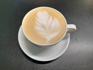 White cup with coffee. Coffee in a white cup on a black background