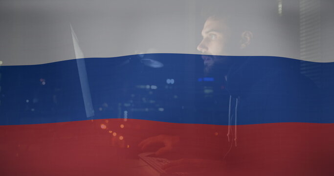 Image of caucasian male hacker over flag of russia